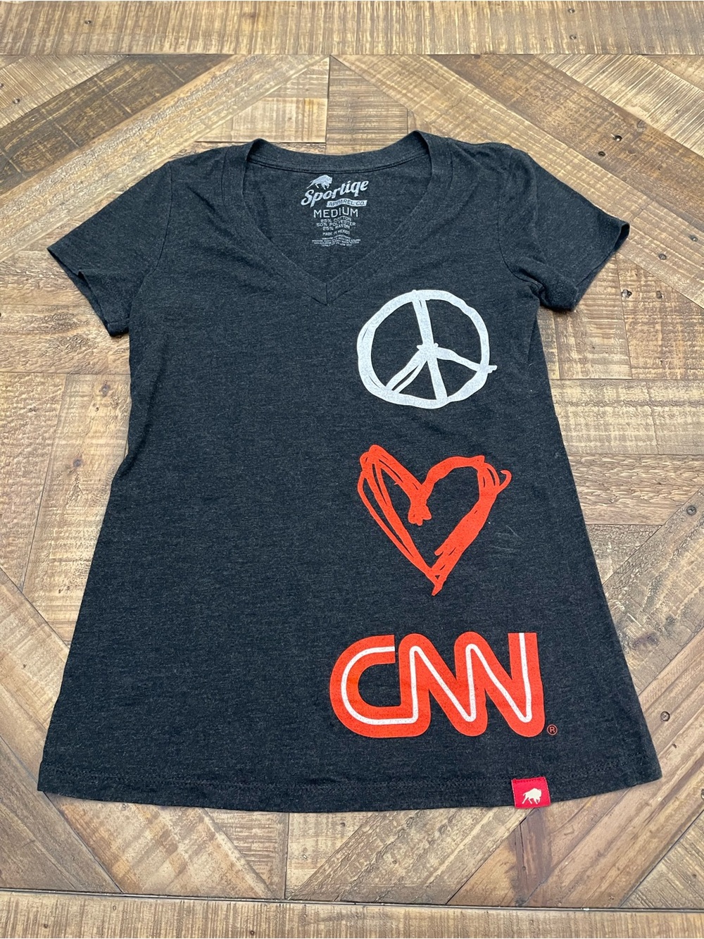 Sportiqe Apparel V-neck tee features a hand-drawn "peace, love, CNN" graphic